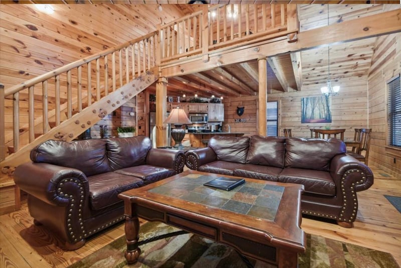 Sink into plush leather sofas surrounded by warm wood walls and beams that create your perfect mountain retreat atmosphere.