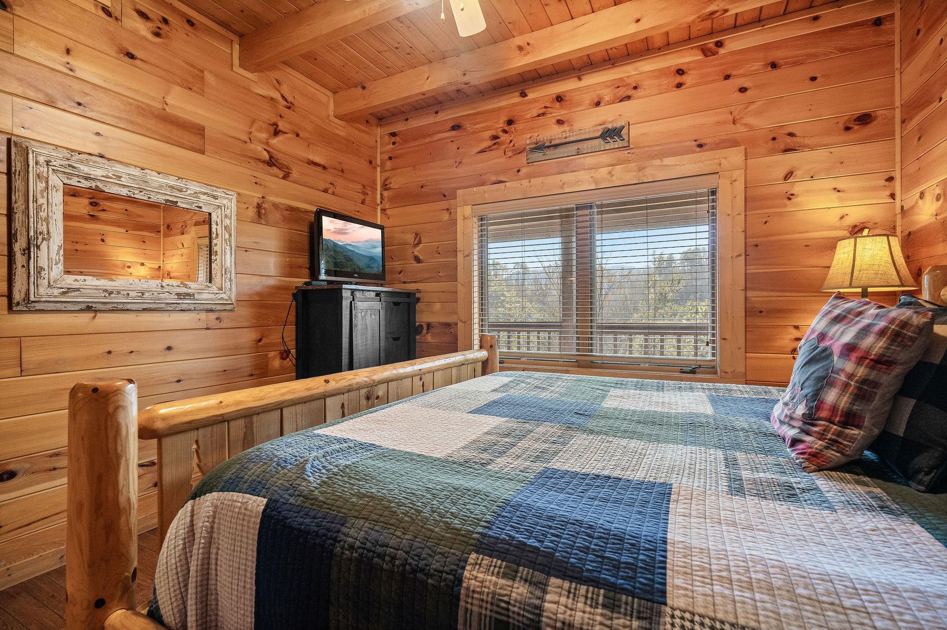 King bed and armoire with TV in a bedroom at Mountain Mama, a 3 bedroom cabin rental located in Pigeon Forge