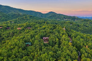 Nestled among lush Smoky Mountain forests, the property offers peaceful seclusion while remaining close to neighboring cabins and scenic hiking trails.