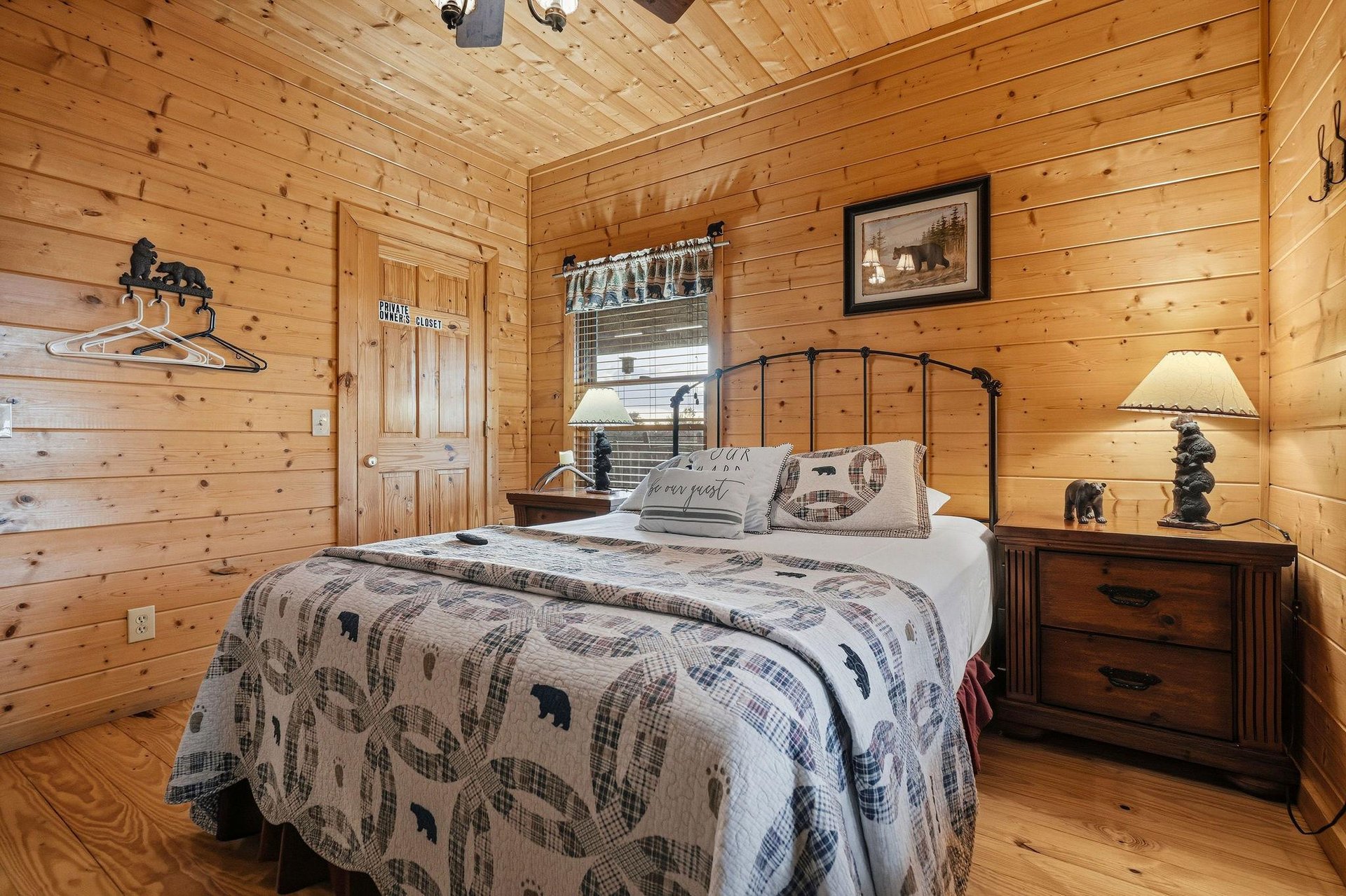 Cozy up in your rustic cabin bedroom with warm pine walls, charming bearthemed decor, and peaceful woodland touches that invite you to unwind after a day of adventure.