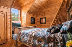 Step into your cozy mountain hideaway with warm wood walls, soft linens, and stunning scenery framed by your window—your perfect retreat.