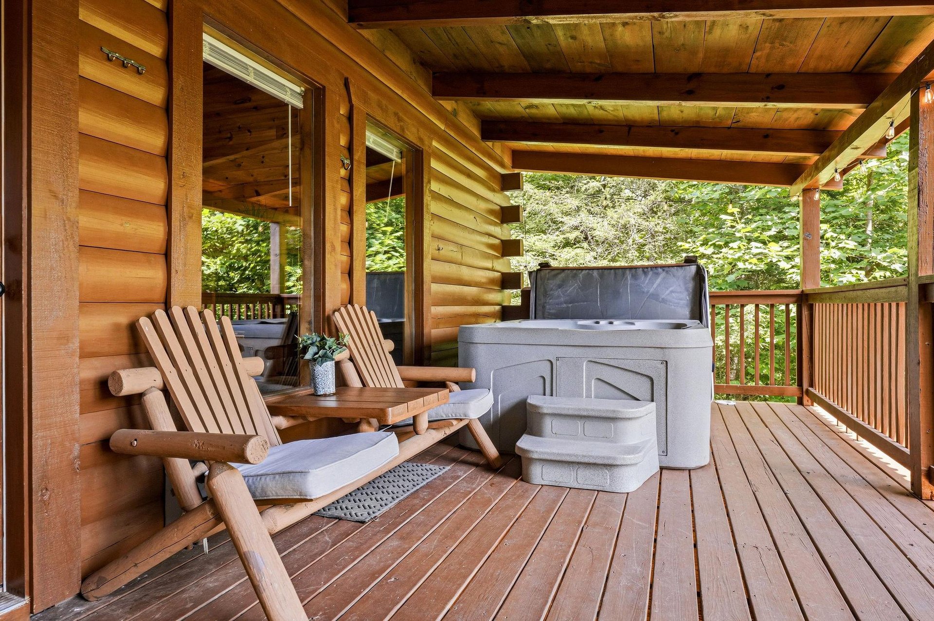 Unwind in your private Adirondack chairs with a hot tub just steps away, surrounded by serene forest views from this covered deck.