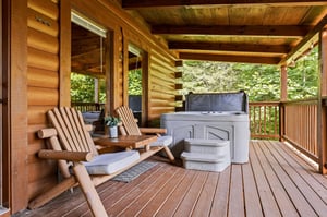 Unwind in your private Adirondack chairs with a hot tub just steps away, surrounded by serene forest views from this covered deck.