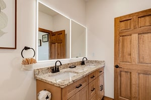 Your dualsink vanity makes morning routines a breeze, with warm wood tones, granite counters, and soft lighting that sets a calm, welcoming tone.
