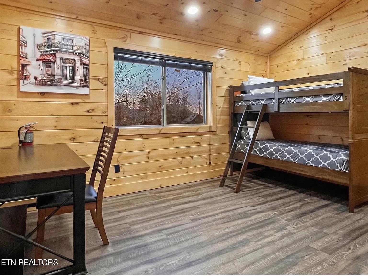Your cozy bunk room features warm wood walls and comfy beds, perfect for family getaways or sharing adventures with friends.