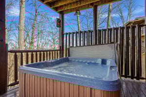 Soak in your private hot tub surrounded by peaceful winter woods, letting warm bubbles melt away stress under the crisp mountain sky.