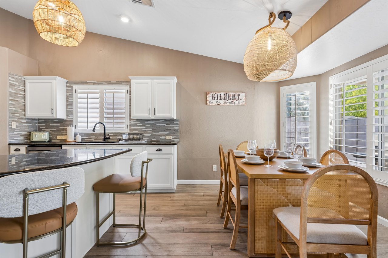 Dining area next to kitchen with table and chairs for 6 guests.