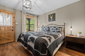 King bed with window and door to deck