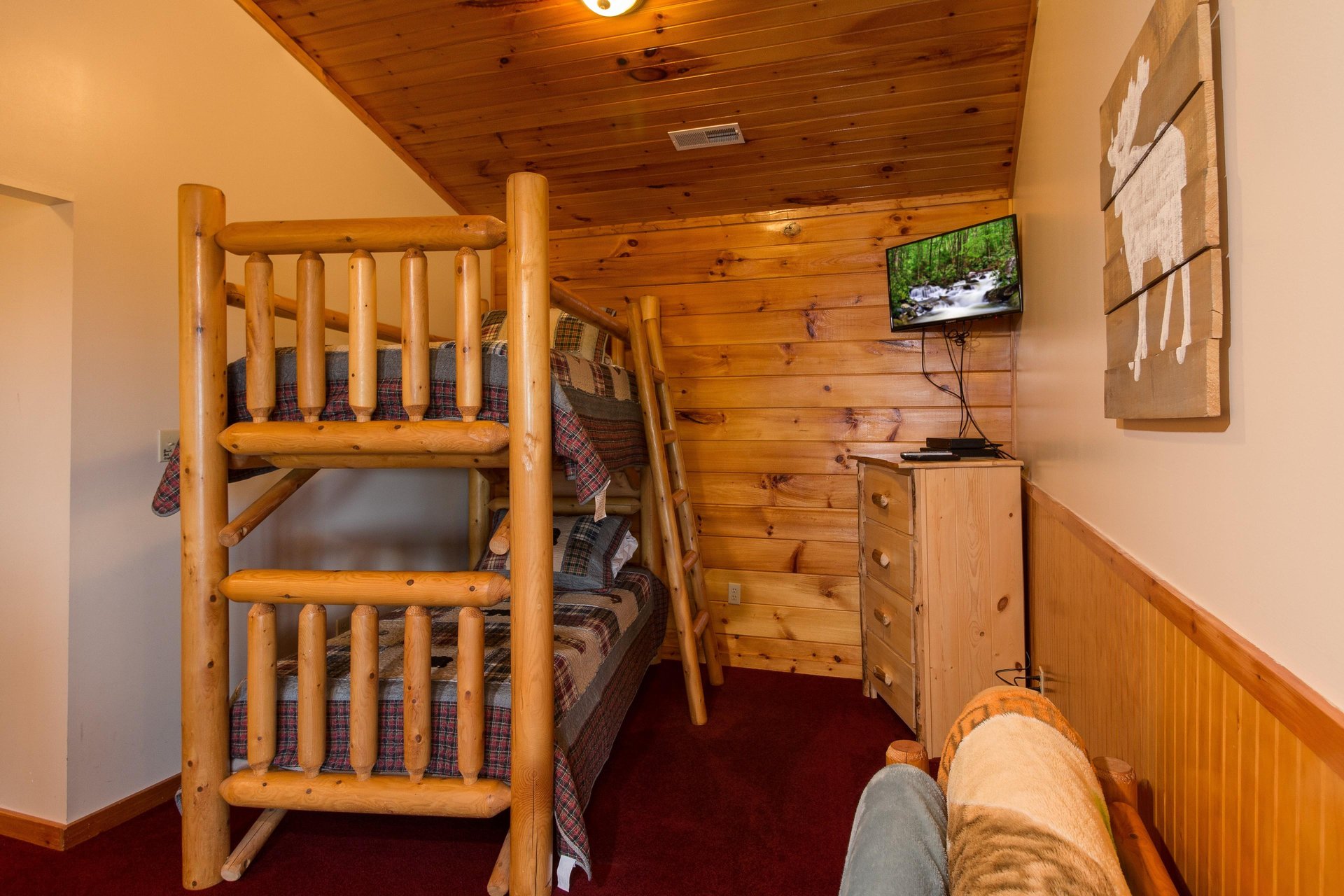 Twin bunk beds, dresser, and TV in a bedroom at Moose Lodge, a 4 bedroom cabin rental located in Sevierville