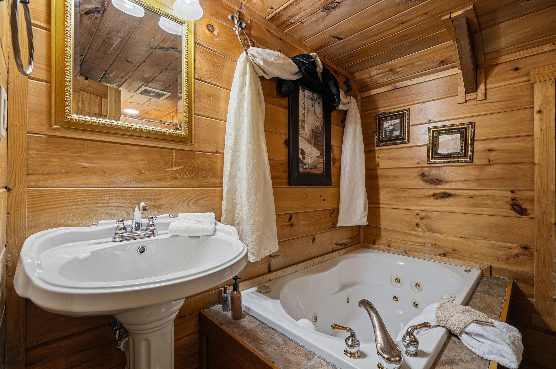 Step into your private bathroom with warm wood walls, a jetted tub for soaking away the day, and fresh towels waiting for you.