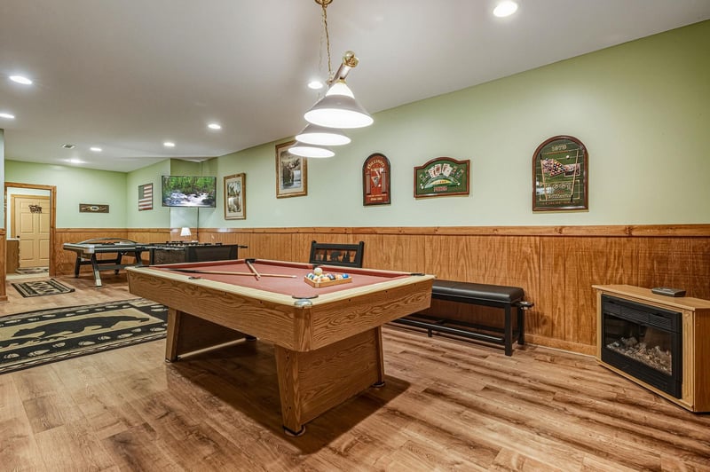 Challenge friends to pool in your private game room, complete with cozy fireplace and stylish seating for ultimate relaxation.