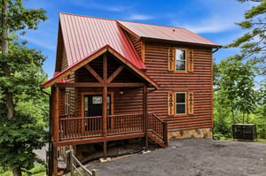 This charming log cabin sits nestled among towering trees, offering a peaceful mountain retreat. The warm wood tones and covered front porch welcome guests to a cozy, naturesurrounded getaway.