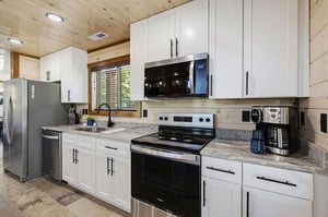 Cook up your favorite meals in this bright, fully equipped kitchen with modern appliances and ample counter space for easy meal prep.