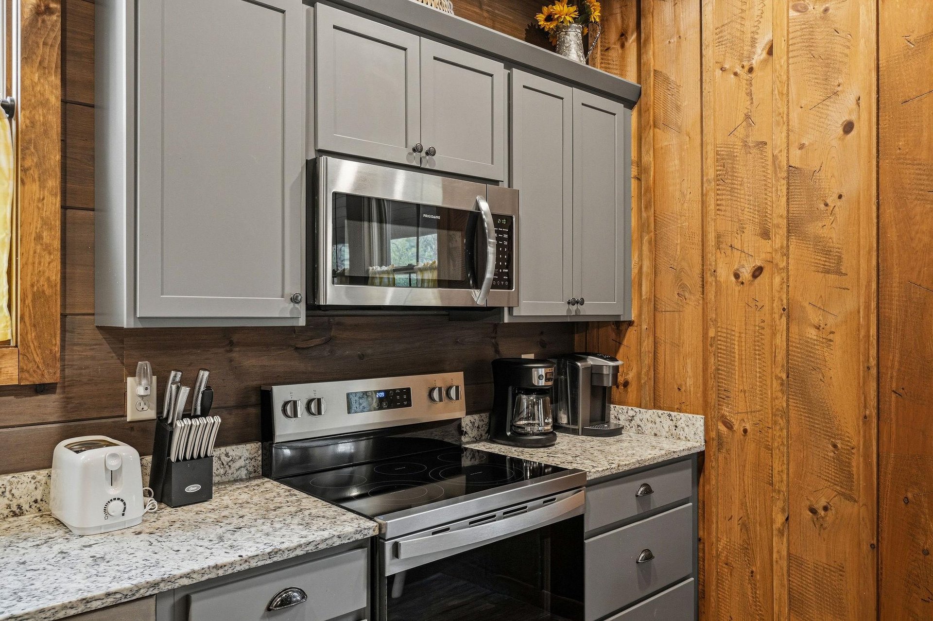 Your fully equipped kitchen awaits with granite counters, modern appliances, and warm wood accents—perfect for preparing cozy meals during your mountain getaway.