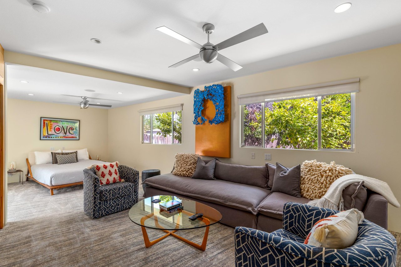 Features a queen size bed, own sitting area, smart TV, patio access, and ensuite bathroom.