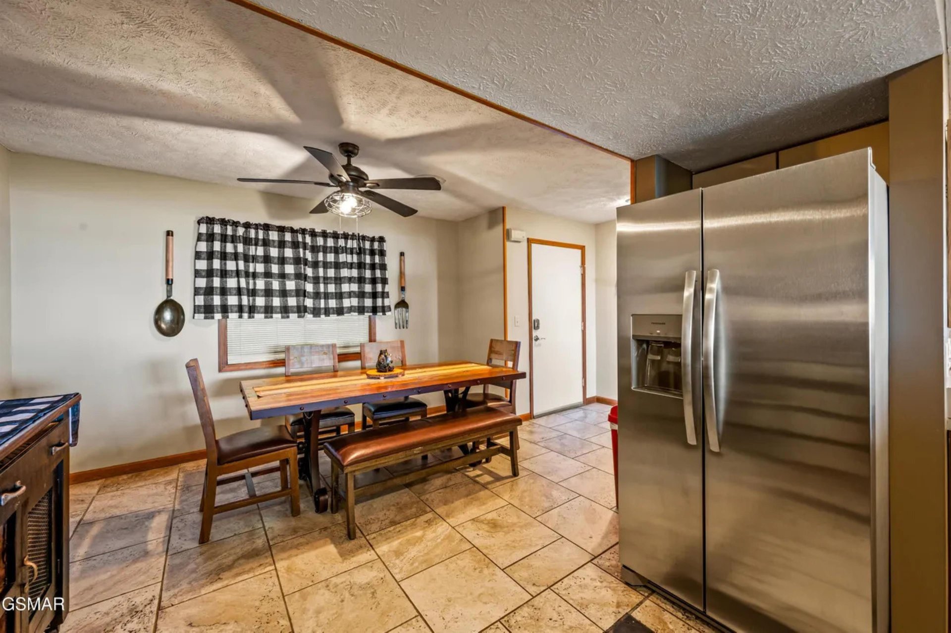 Gather around your rustic dining table for memorable meals, with modern stainless appliances and charming farmhouse touches creating the perfect blend of comfort and convenience.