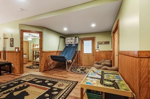 Your private game room awaits with basketball hoops, pool cues, and cozy seating for endless entertainment.