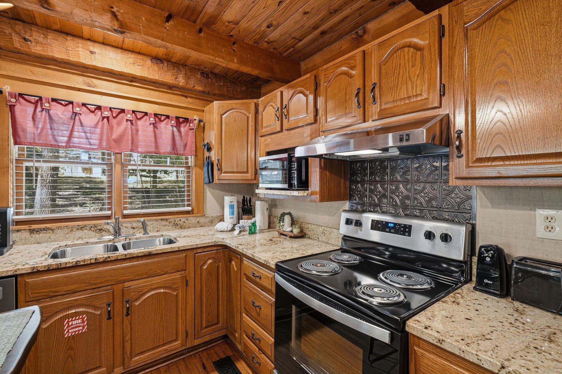 Your fullyequipped kitchen awaits with warm wood cabinetry, granite countertops, and everything needed to whip up delicious meals during your stay.