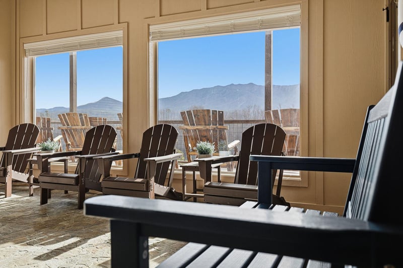 Step onto your private deck where mountain views stretch endlessly beyond comfortable Adirondack chairs, perfect for morning coffee or evening relaxation.