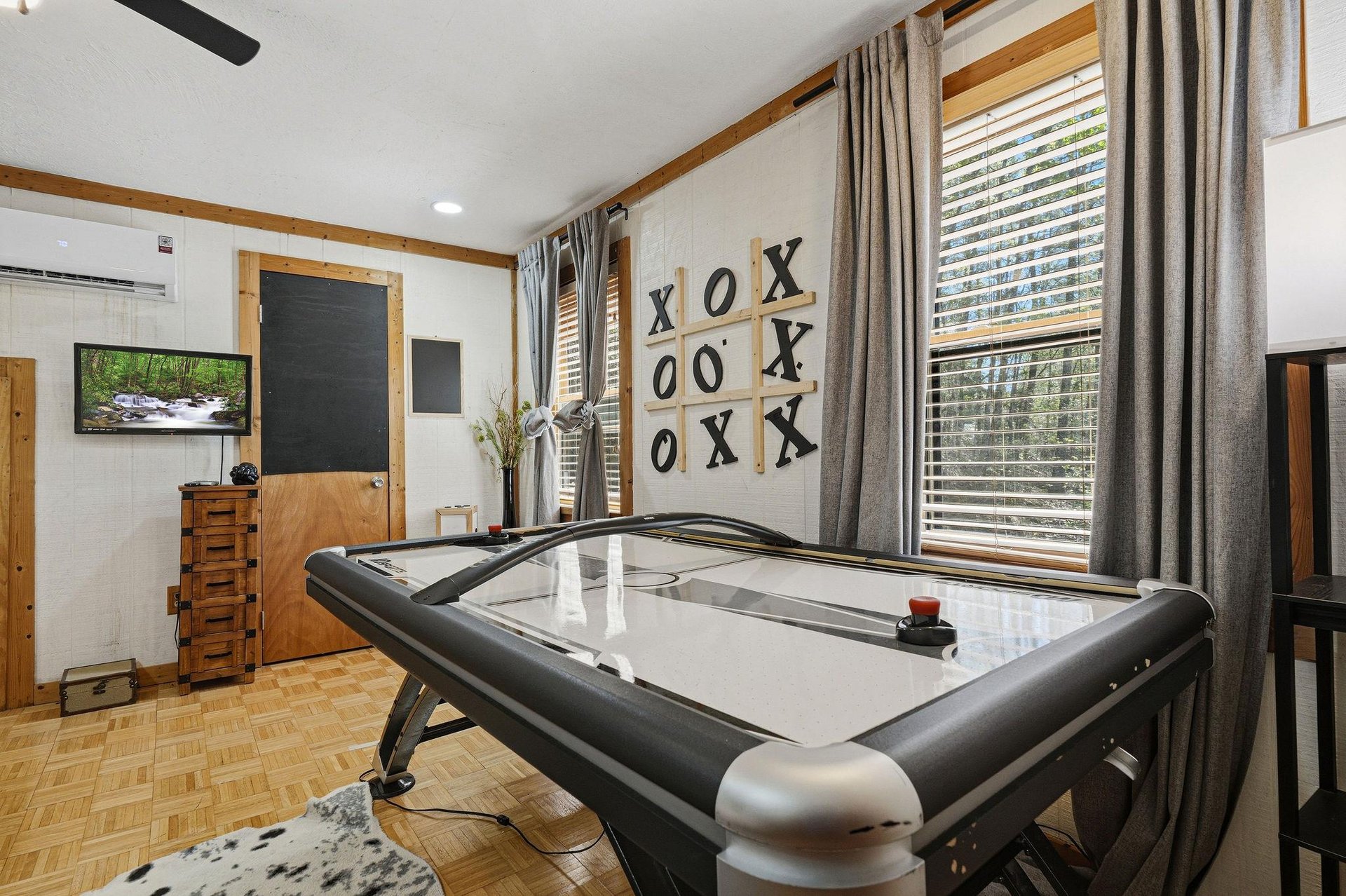 Challenge friends to air hockey in your private game room, complete with entertainment and cozy seating.