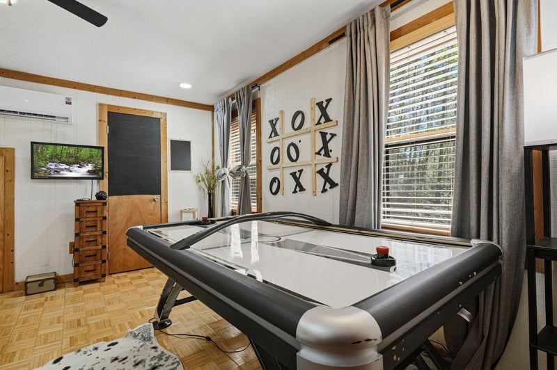 Challenge friends to air hockey in your private game room, complete with entertainment and cozy seating.