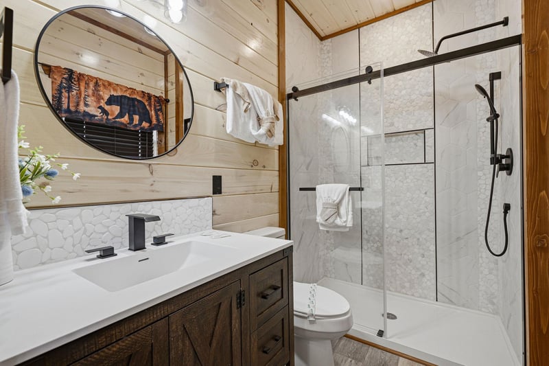 Step into your private rustic retreat with modern marble shower, cozy cabin accents, and thoughtful touches that make you feel right at home.