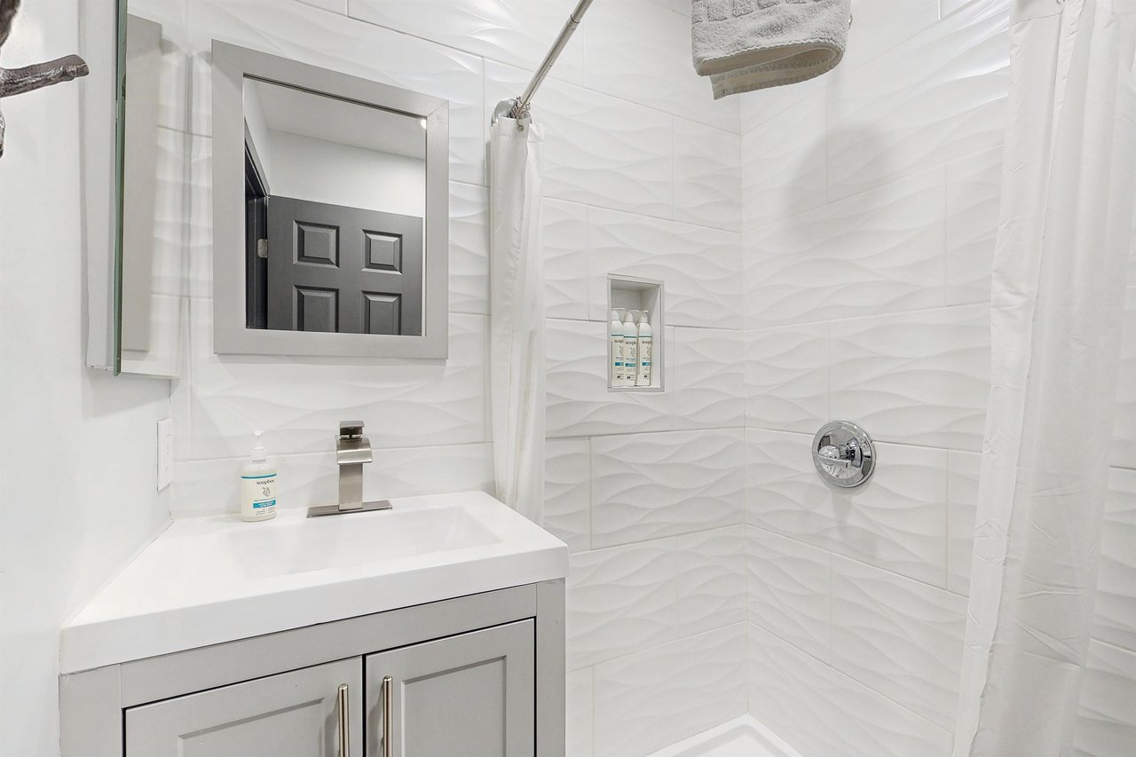 Full guest bathroom with a stand alone shower located near the 2 guest bedrooms.