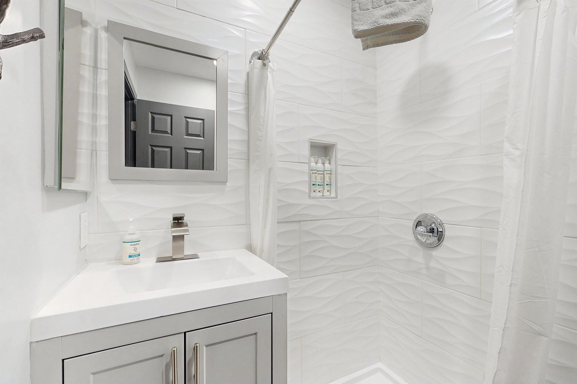 Full guest bathroom with a stand alone shower located near the 2 guest bedrooms.