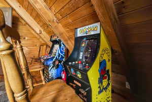 Challenge your friends to classic arcade games in this rustic game loft. Warm wood beams create a cozy retreat where you can relive gaming nostalgia.