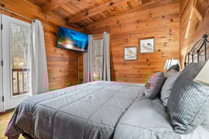 King bed with window and door to deck