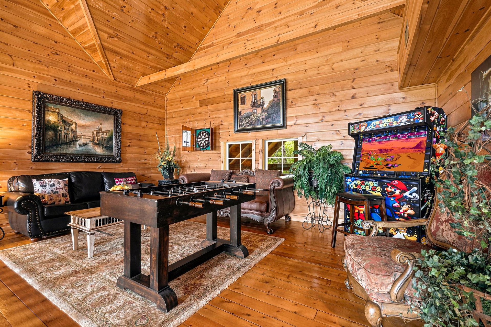 Step into your own private game room, where vaulted wood ceilings create an inviting space for friendly competition at the foosball table, arcade games, and dartboard.