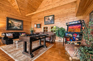Step into your own private game room, where vaulted wood ceilings create an inviting space for friendly competition at the foosball table, arcade games, and dartboard.