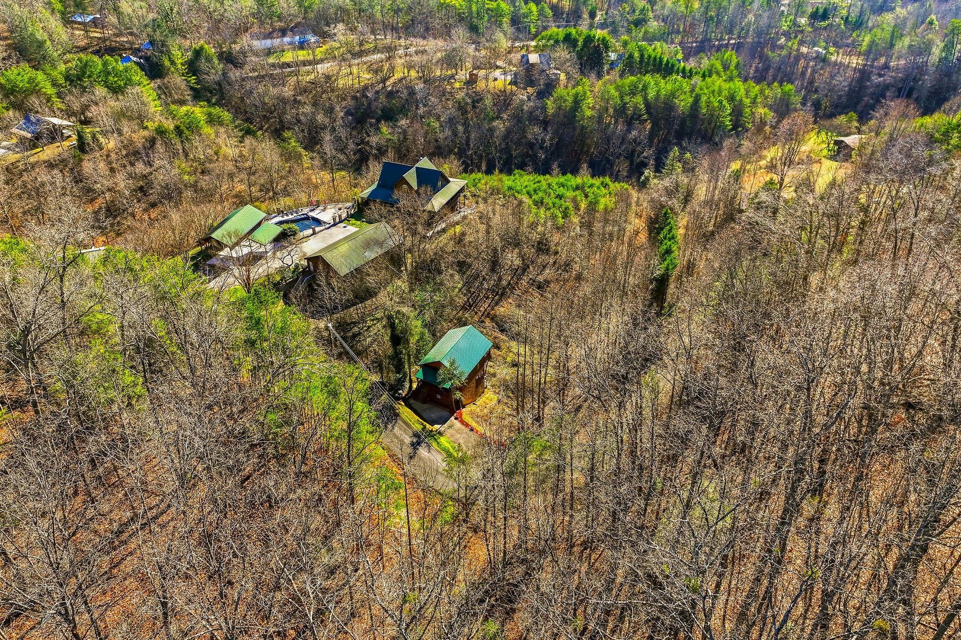 Aerial view showcasing the property nestled among vast woodlands and natural forest landscape in a peaceful rural setting.