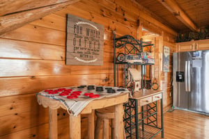 Your fullyequipped kitchen features a charming rustic feel, complete with a large refrigerator, cozy breakfast bar, and thoughtful touches that make cooking feel like home.