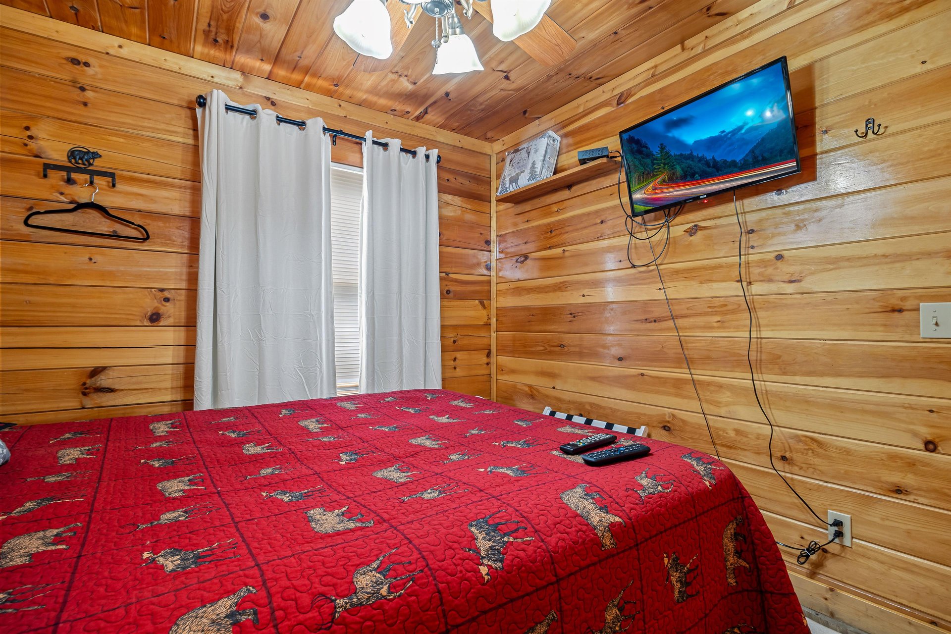 Queen bed with window and tv