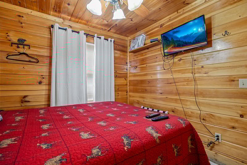 Queen bed with window and tv