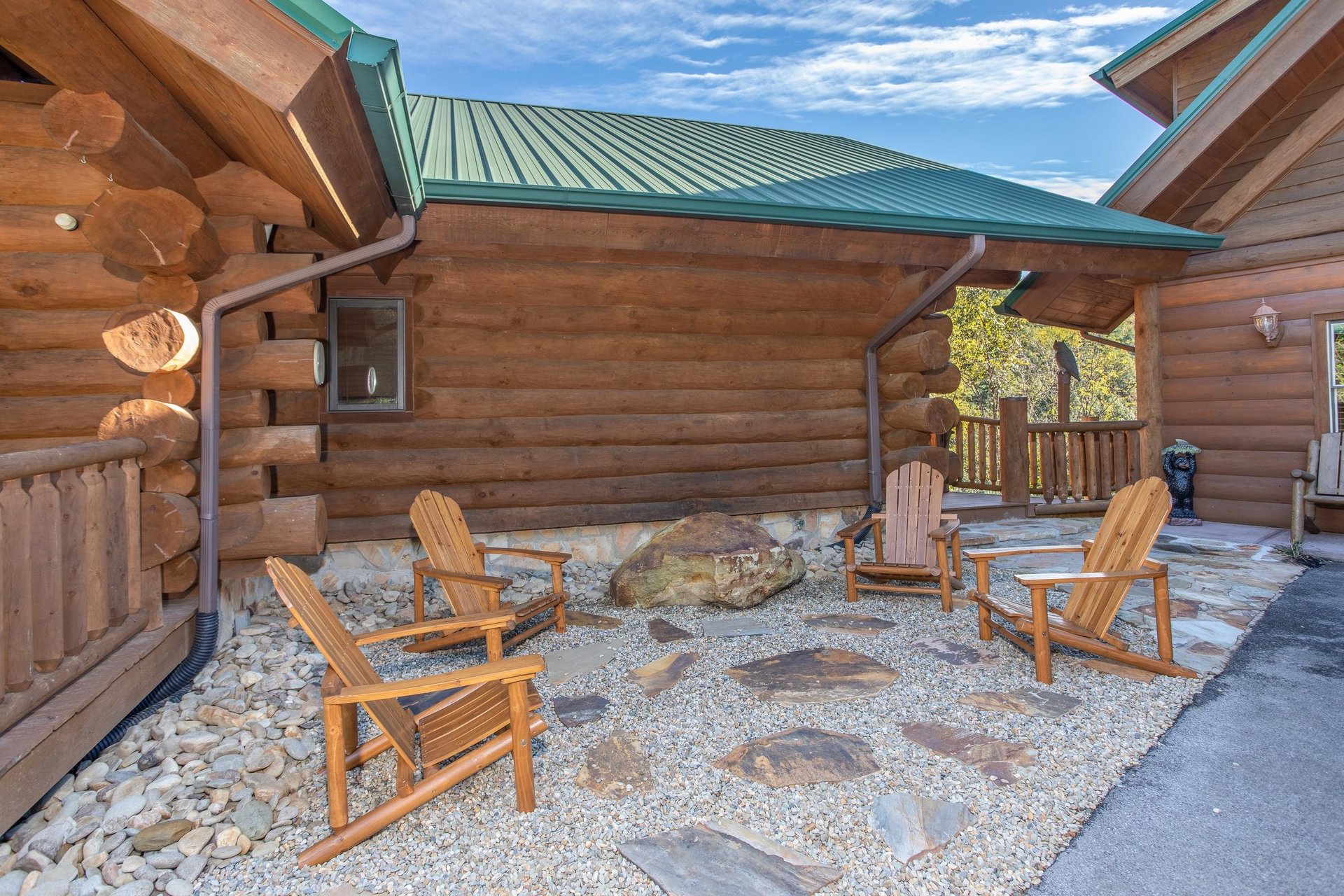 Four Adirondack chairs on a stone patio at Great View Lodge, a 5bedroom cabin rental located in Pigeon Forge