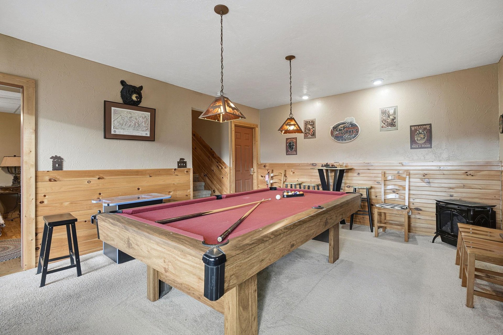 Challenge your friends to a game in this cozy recreation room, featuring rustic wood accents and mountainthemed decor for perfect aprèsski entertainment.