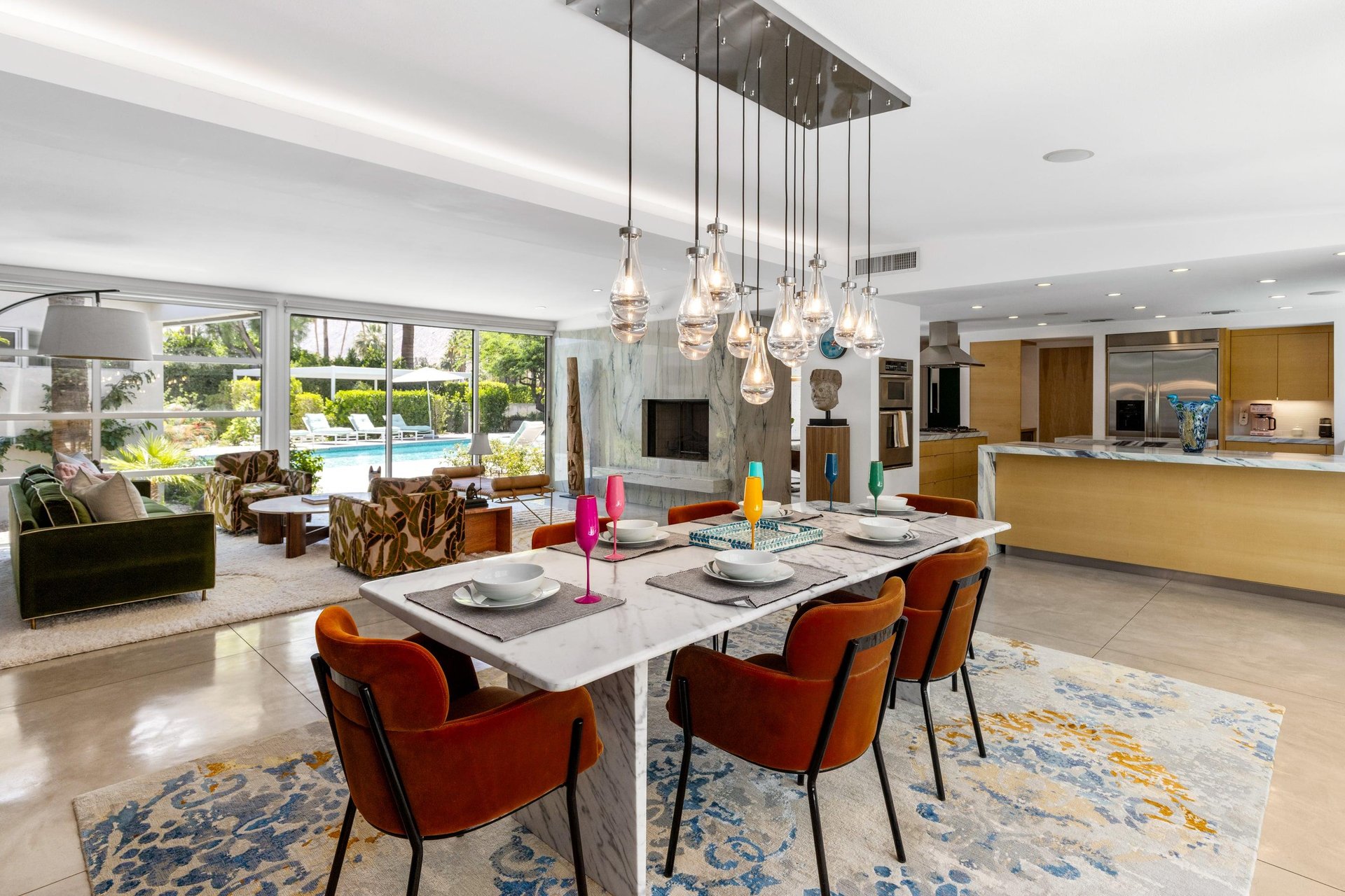Dine at a marble table set for 6 under a beautiful chandelier.