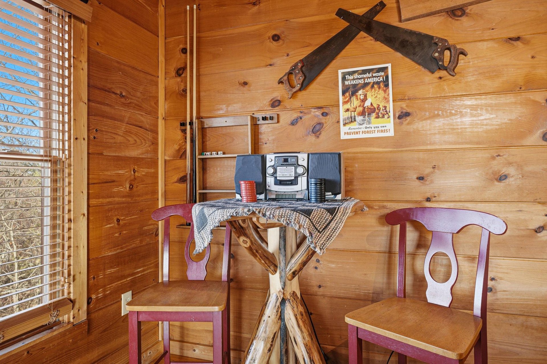 Step into rustic charm with handcrafted wooden table, vintage stereo, and authentic cabin details that make your mountain getaway feel like home.