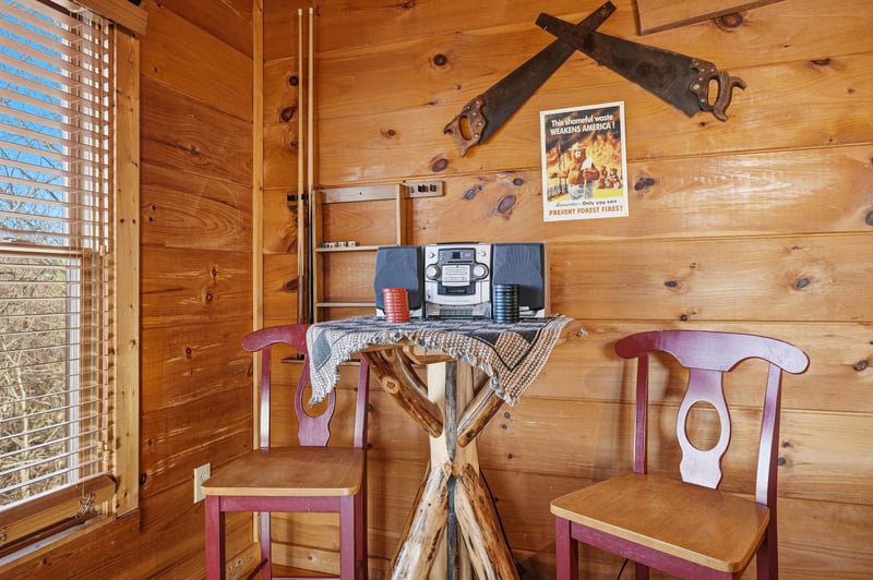 Step into rustic charm with handcrafted wooden table, vintage stereo, and authentic cabin details that make your mountain getaway feel like home.