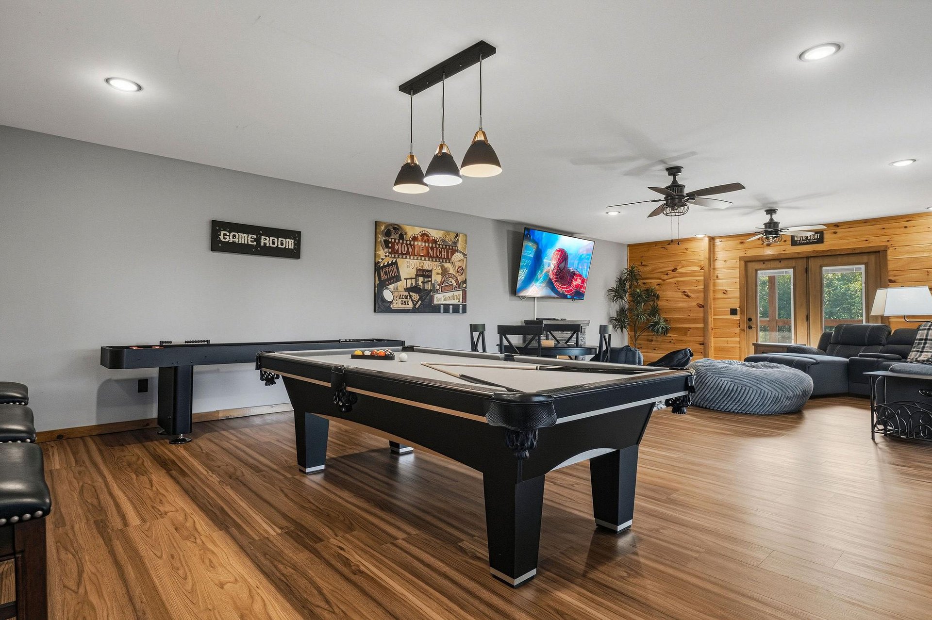 Gather everyone for friendly competition in this spacious game room, where youll find a pool table and more—perfect for evenings filled with laughter and fun.
