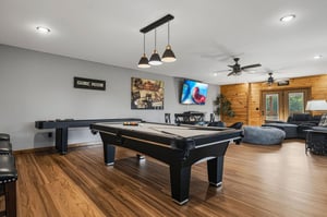 Gather everyone for friendly competition in this spacious game room, where youll find a pool table and more—perfect for evenings filled with laughter and fun.