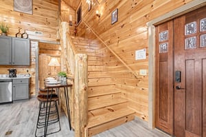 Step into this cozy cabin where rustic wood beams and warm lighting create your perfect mountain retreat atmosphere.