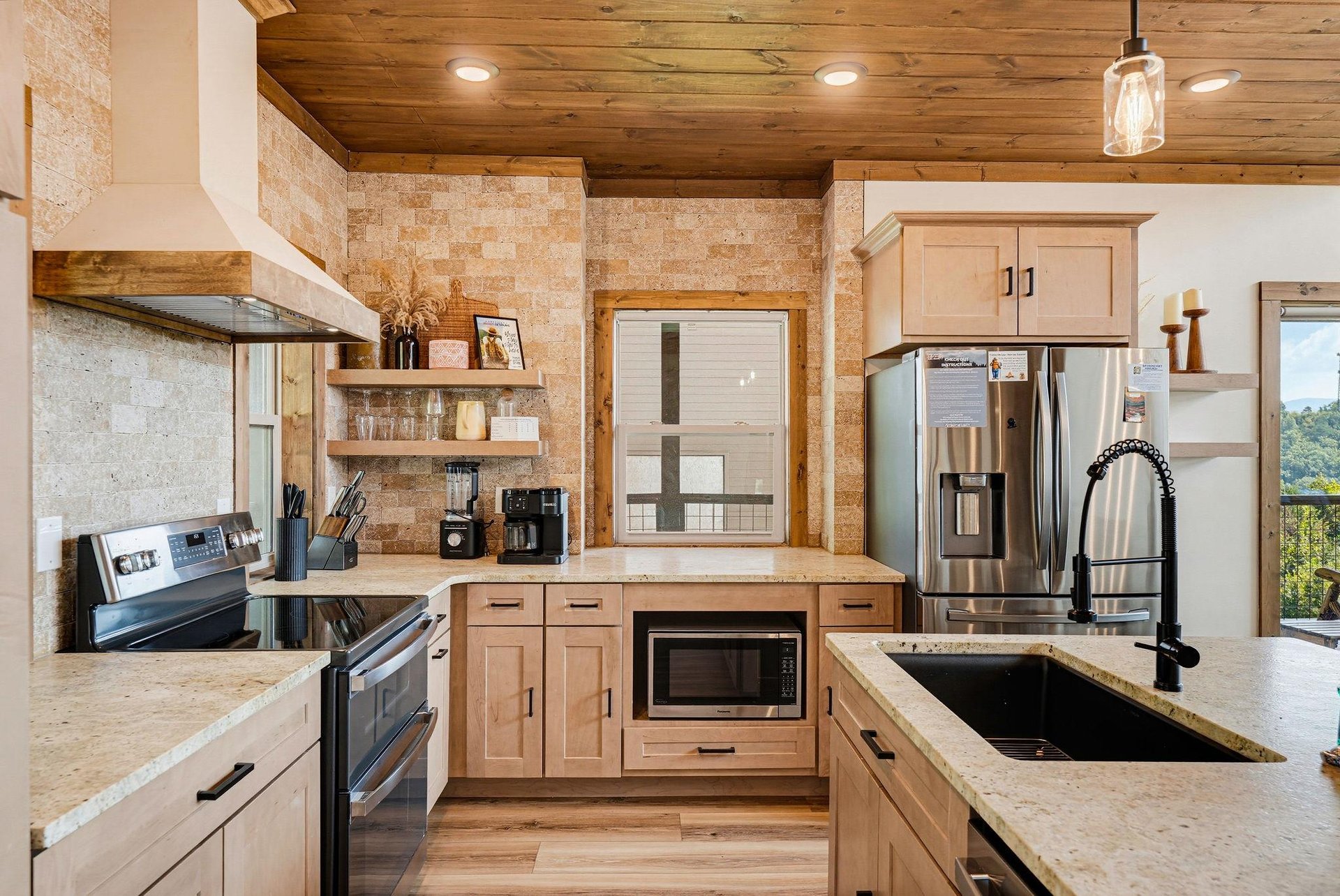 A beautifully designed kitchen awaits, blending rustic warmth with modern convenience. Gleaming appliances, natural wood finishes, and thoughtful details make your vacation cooking feel effortless and