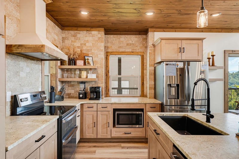 A beautifully designed kitchen awaits, blending rustic warmth with modern convenience. Gleaming appliances, natural wood finishes, and thoughtful details make your vacation cooking feel effortless and