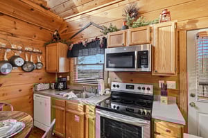 Your fully equipped rustic kitchen features warm wood cabinets and all the appliances you need to prepare memorable meals during your stay.