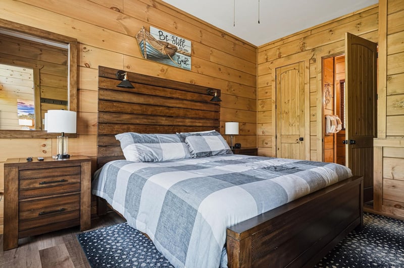 Drift into peaceful sleep in your cozy cabin bedroom, where rustic wood walls and soft linens create the perfect mountain retreat.