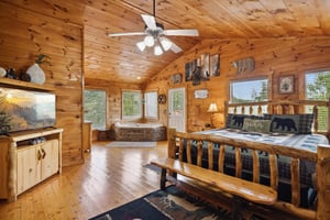 King bed with bench and jacuzzi in corner