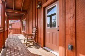 Your private covered porch invites relaxation with a classic rocking chair where you can unwind and soak in peaceful mountain moments.